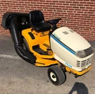 2130 Cub Cadet Riding Tractor + Twin Rear Bagger (used). Fixed Price $1265.00.